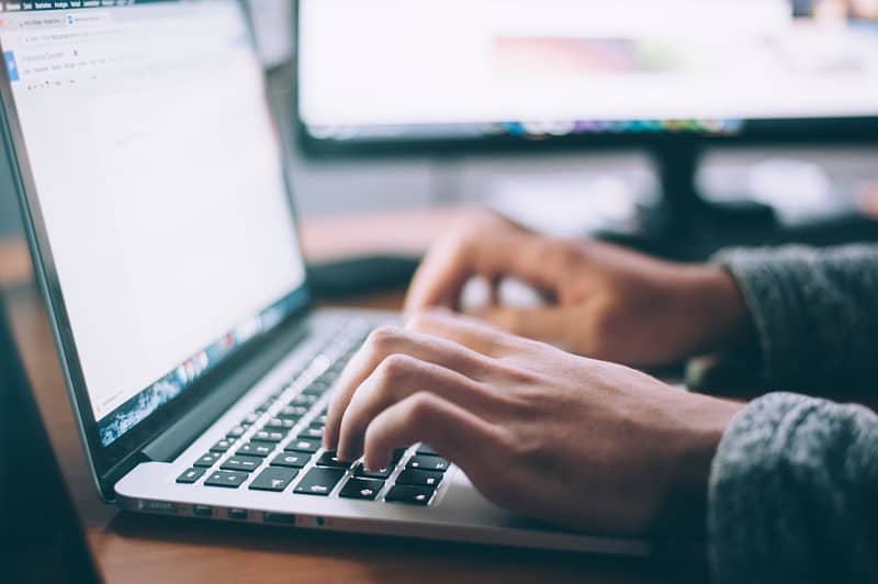 person typing on laptop