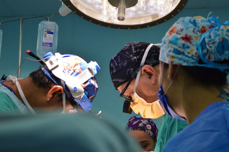 surgeons performing a surgery