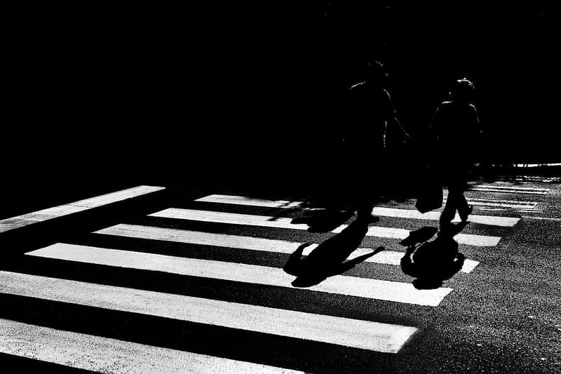 two people using a pedestrian crossing