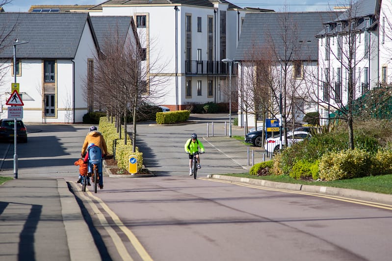 people riding their bikes on the street