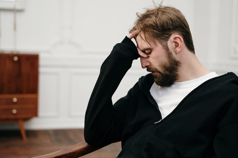 Man looking stressed in chair