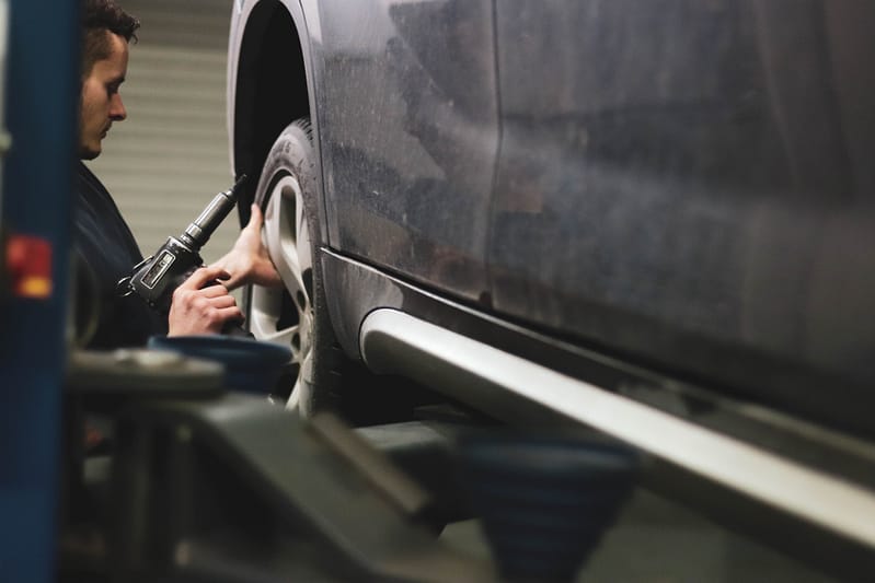 A mechanic inspecting a tyre