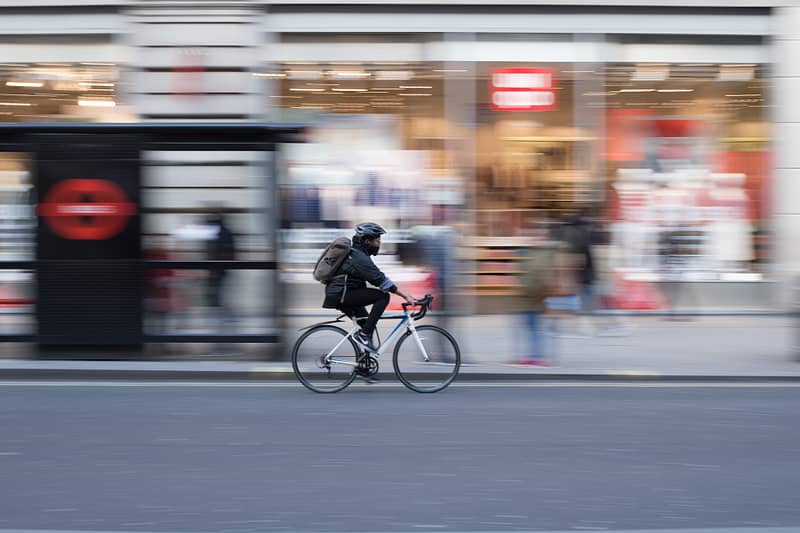 A cyclist next to a bus stop