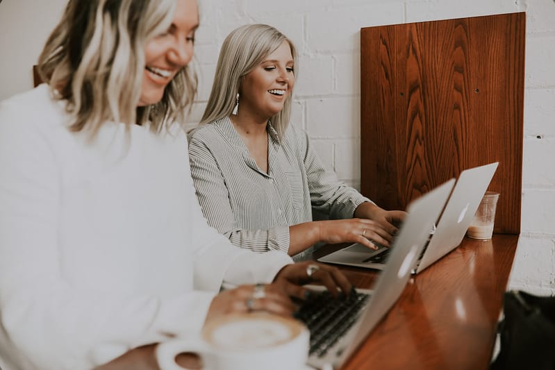 Two people smiling in an office