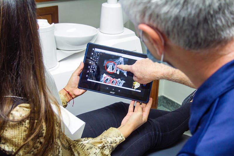 A doctor with a patient talking with them about an x ray