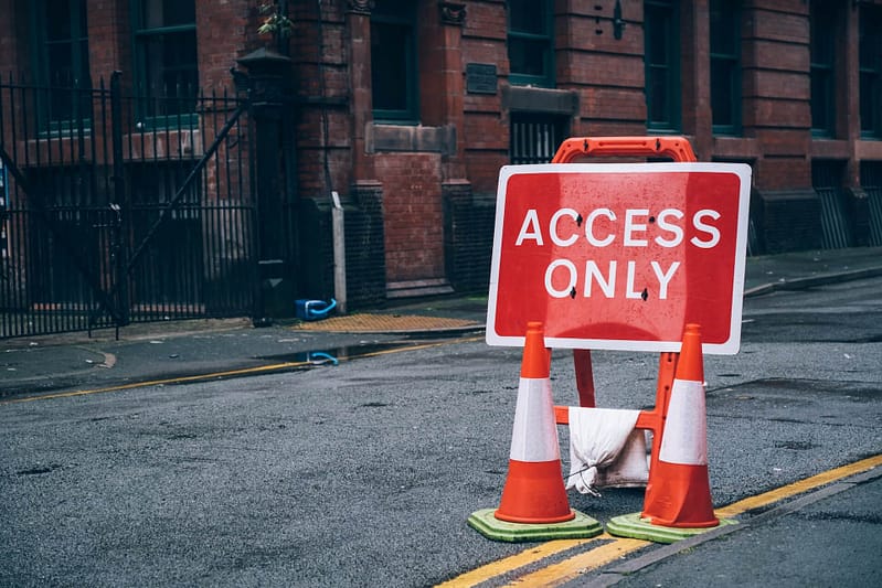 An 'access only' sign on a path