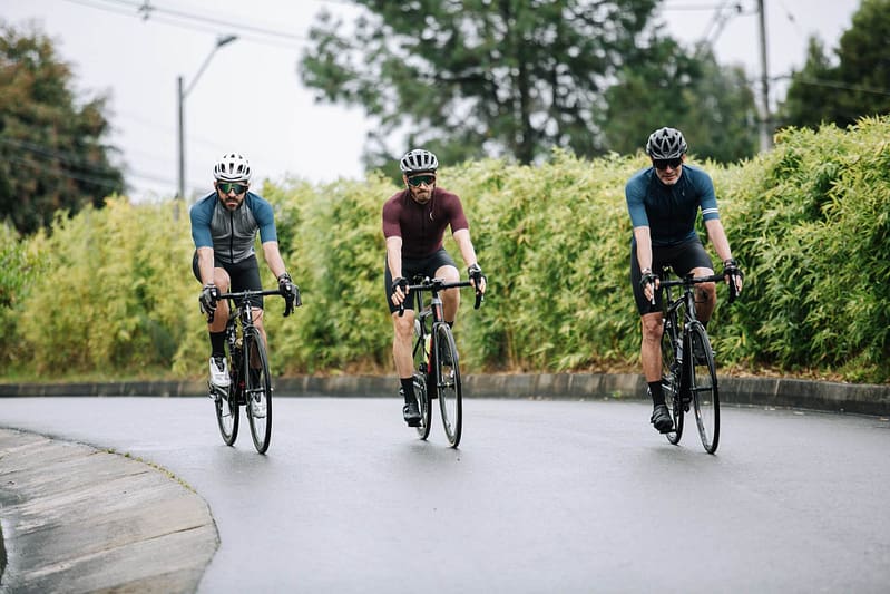 Three people cycling