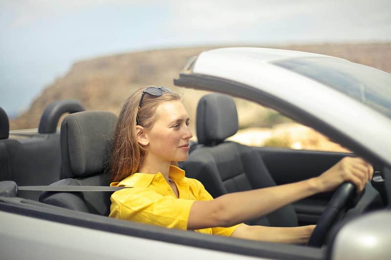 A young person driving their car