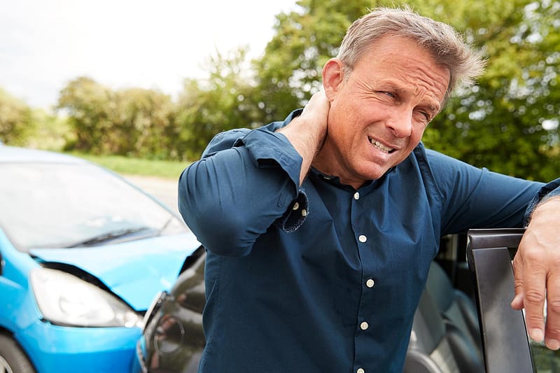 male motorist with whiplash injury