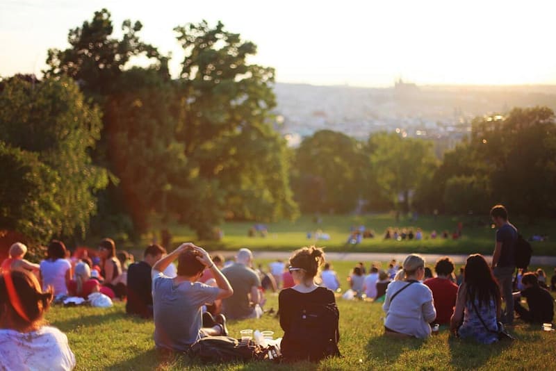 a busy park during a sunset