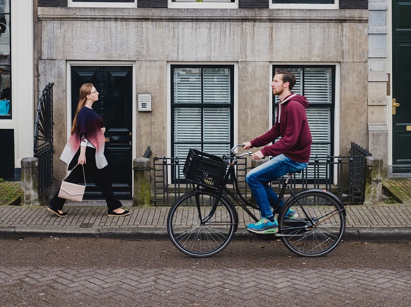 A cyclist and pedestrian crossing paths