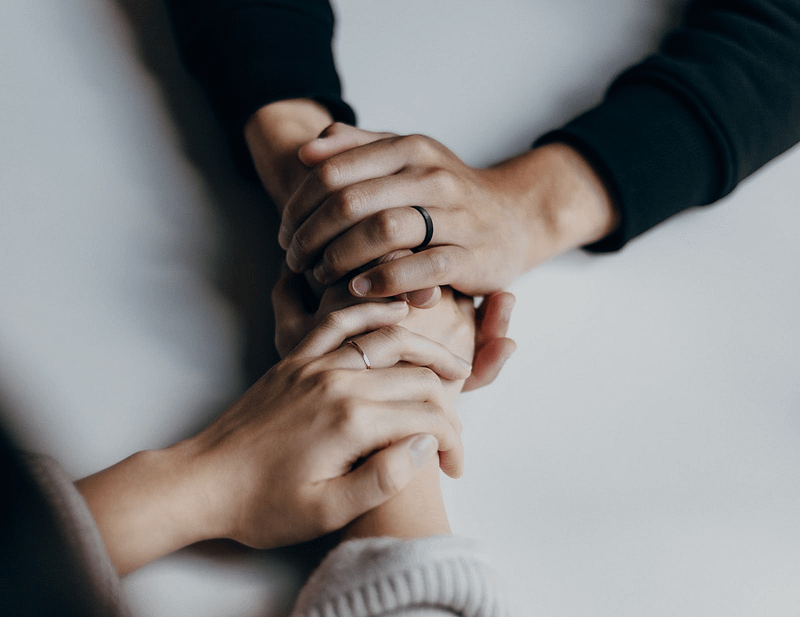 two women holding hands on a table