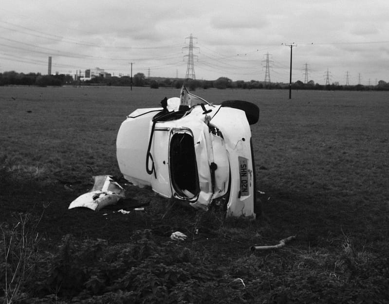 A crashed car in a field