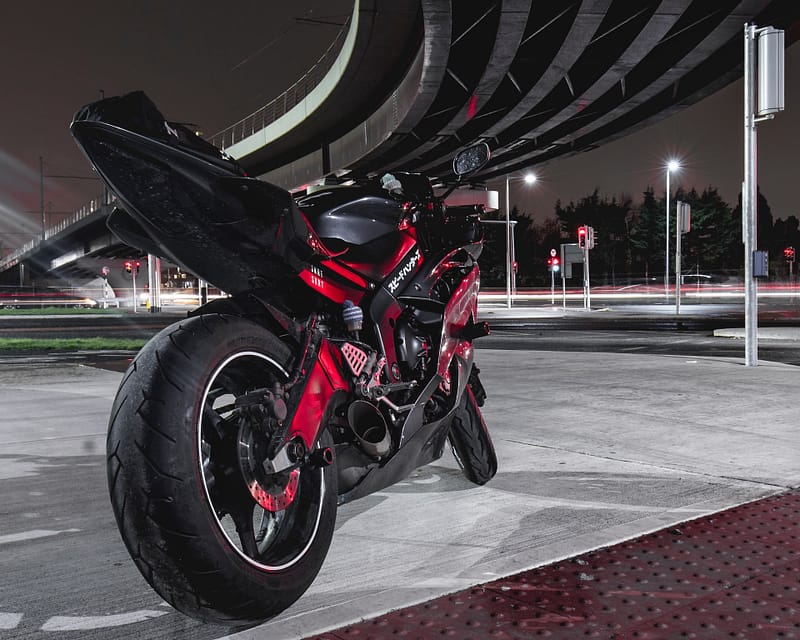 A motorbike parked in a car park at night