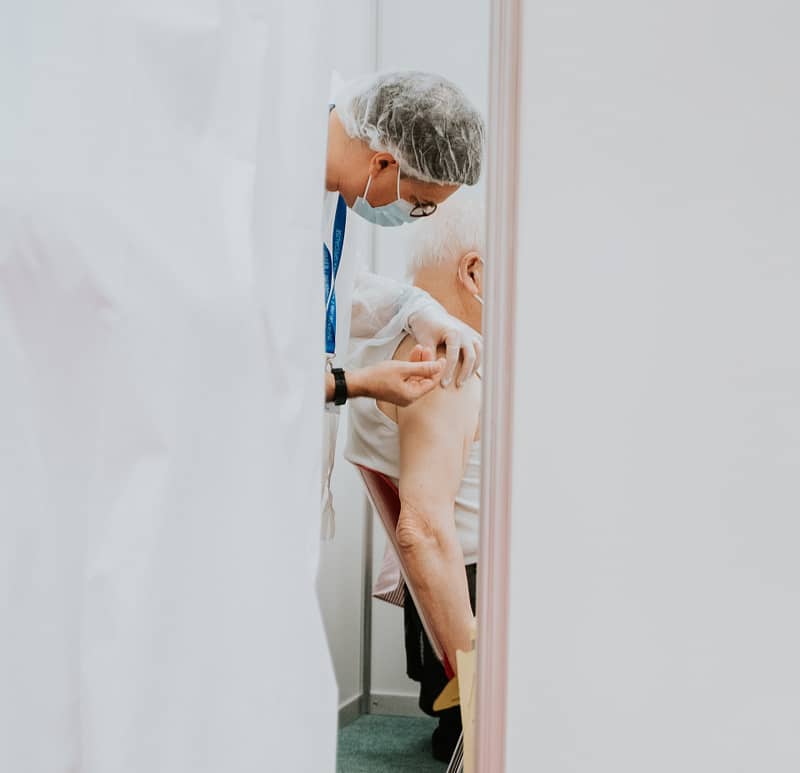 An elderly patient getting an injection